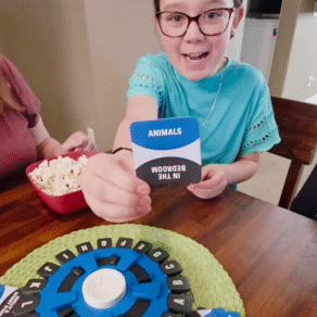 Child playing the Tapple word game during family game night at home