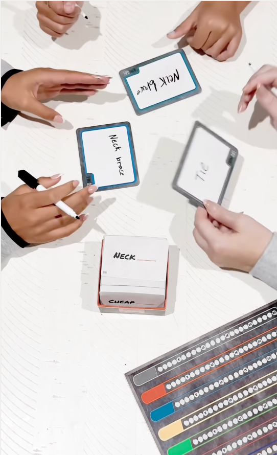 Players writing answers on Blank Slate cards during a family game night